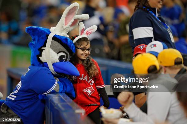 Young fan and Junior, teh Jays mascot pose for a photo wearing Bunny Ears for Easter Sunday before the MLB game between the New York Yankees and the...