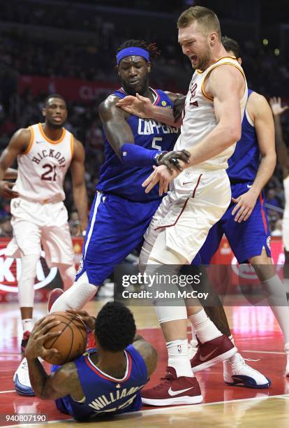 Domantas Sabonis of the Indiana Pacers looks down at Lou Williams of the Los Angeles Clippers after he lost the ball, Montrezl Harrell of the Los...