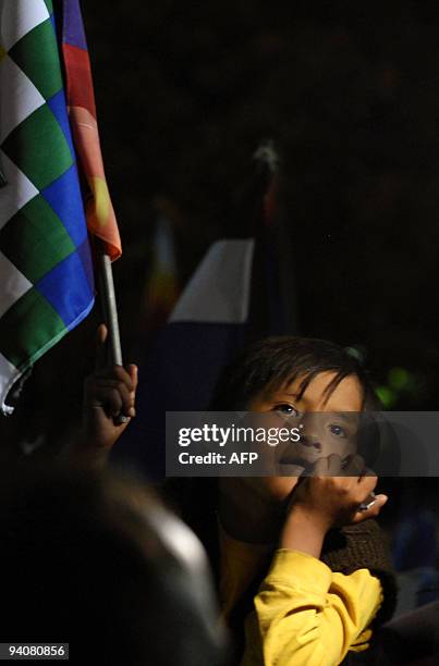 Kid holds a flag celebrating Bolivian President Evo Morales' reelection in La Paz on Diciembre 6, 2009. Bolivia's leftist President Evo Morales won a...