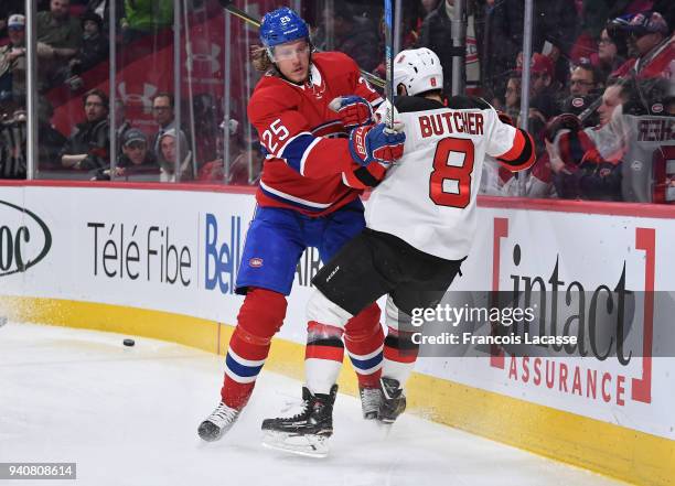 Jacob De La Rose of the Montreal Canadiens checks Will Butcher of the New Jersey Devils in the NHL game at the Bell Centre on April 1, 2018 in...