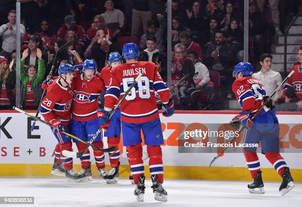 Daniel Carr of the Montreal Canadiens celebrates with teammates after scoring a goal against the New Jersey Devils in the NHL game at the Bell Centre...