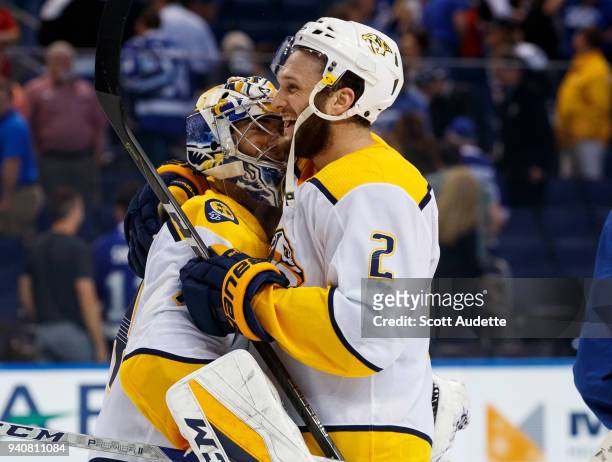 Goalie Juuse Saros and Anthony Bitetto of the Nashville Predators celebrate the win against the Tampa Bay Lightning at Amalie Arena on April 1, 2018...