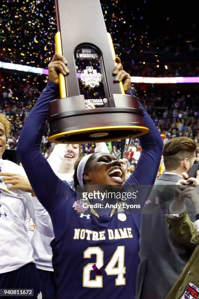Arike Ogunbowale of the Notre Dame Fighting Irish hoist the NCAA championship trophy after scoring the game winning basket to defeat the Mississippi...