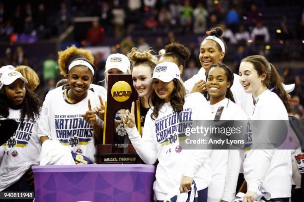 Marina Mabrey of the Notre Dame Fighting Irish and her teammate celebrate with the NCAA championship trophy after defeating the Mississippi State...
