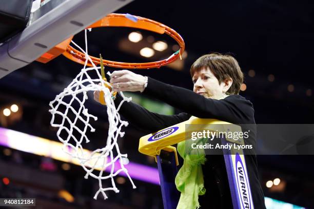 Head coach Muffet McGraw of the Notre Dame Fighting Irish cuts down the net after her team defeated the Mississippi State Lady Bulldogs in the...