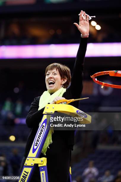 Head coach Muffet McGraw of the Notre Dame Fighting Irish cuts down the net after her team defeated the Mississippi State Lady Bulldogs in the...