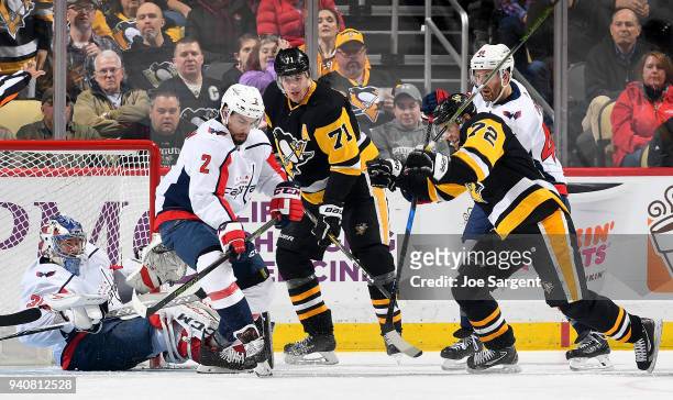 Philipp Grubauer of the Washington Capitals protects the net against Patric Hornqvist of the Pittsburgh Penguins at PPG Paints Arena on April 1, 2018...