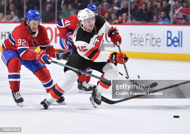 Sami Vatanen of the New Jersey Devils skates for the puck against Jonathan Drouin of the Montreal Canadiens in the NHL game at the Bell Centre on...