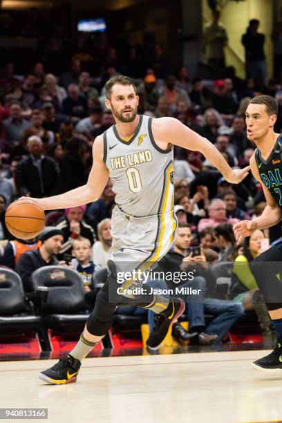 Kevin Love of the Cleveland Cavaliers drives around Dwight Powell of the Dallas Mavericks during the second half at Quicken Loans Arena on April 1,...