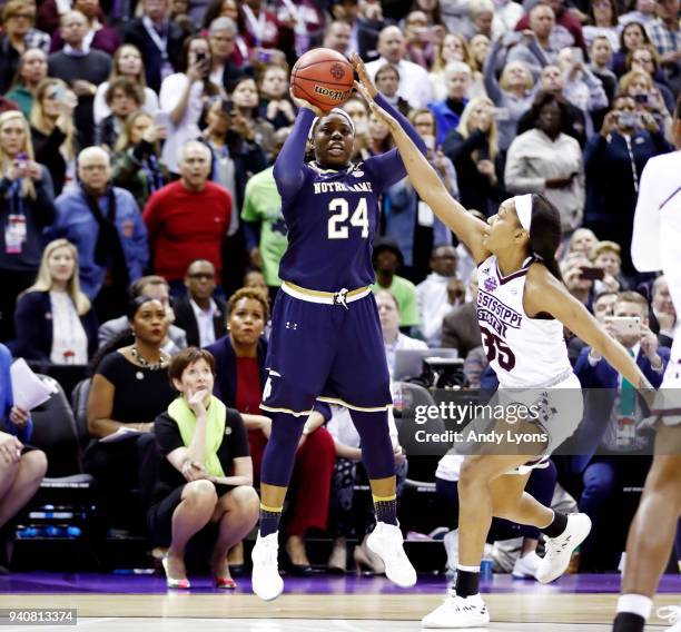 Arike Ogunbowale of the Notre Dame Fighting Irish hits the game winning shot with 0.1 seconds remaining in the fourth quarter under pressure from...