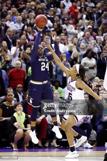 Arike Ogunbowale of the Notre Dame Fighting Irish hits the game winning shot with 0.1 seconds remaining in the fourth quarter under pressure from...