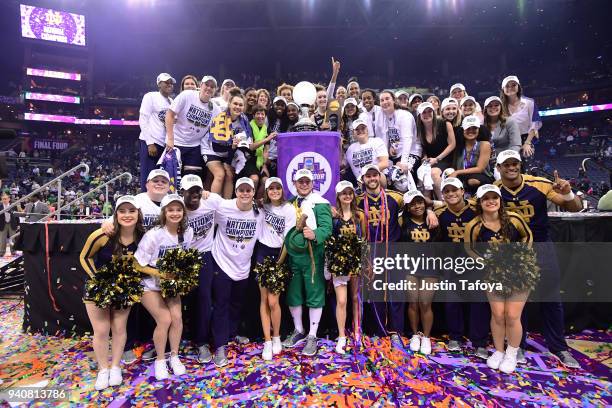 Notre Dame players pose with the trophy after winning the championship against Mississippi State during the championship game of the 2018 NCAA Photos...