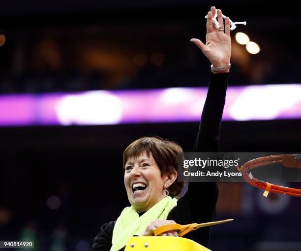 Head coach Muffet McGraw of the Notre Dame Fighting Irish cuts down the net after her team defeated the Mississippi State Lady Bulldogs in the...