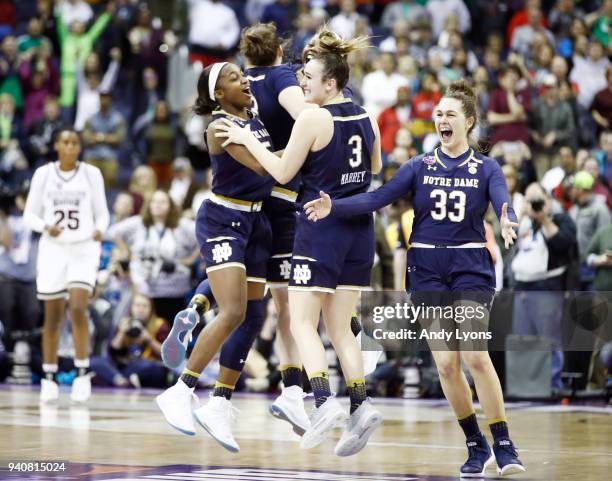 Arike Ogunbowale of the Notre Dame Fighting Irish is congratulated by her teammates Marina Mabrey, Kathryn Westbeld, Jessica Shepard and Jackie Young...