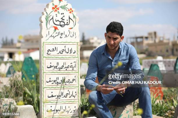 Abdulhamid Yusuf, who lost 19 members of his family, including his wife and two children, visits the graves of his relatives in Khan Shaykhun, on...