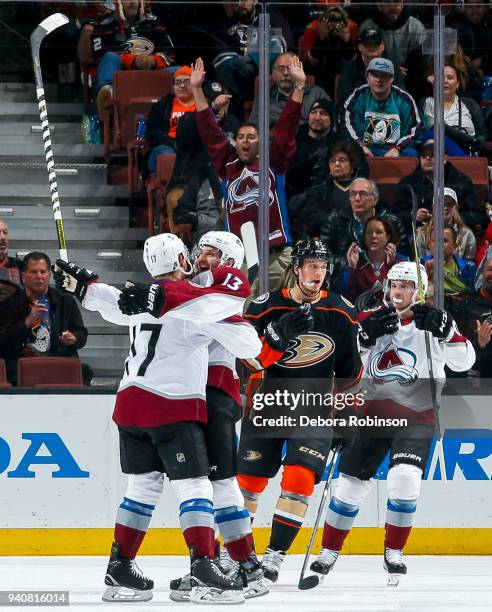 Tyson Jost and Alexander Kerfoot of the Colorado Avalanche celebrate as Rickard Rakell of the Anaheim Ducks reacts after Kerfoot scored a...