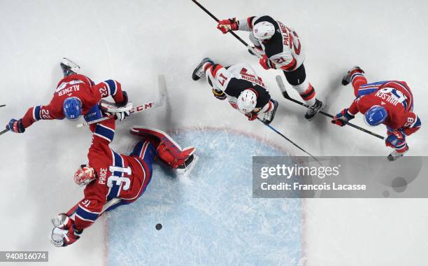 New Jersey Devils misses the net against Carey Price the Montreal Canadiens in the NHL game at the Bell Centre on April 1, 2018 in Montreal, Quebec,...