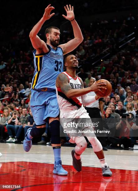 Damian Lillard of the Portland Trail Blazers drives against Marc Gasol of the Memphis Grizzlies at Moda Center on April 1, 2018 in Portland,...