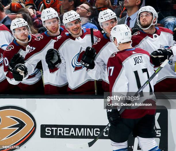 Tyson Jost of the Colorado Avalanche celebrates his second-period goal with players on the bench during the game against the Anaheim Ducks at Honda...