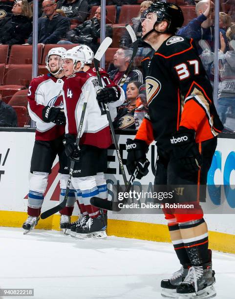 Alexander Kerfoot, Tyson Barrie and Tyson Jost of the Colorado Avalanche celebrate as Nick Ritchie of the Anaheim Ducks reacts after Jost's...