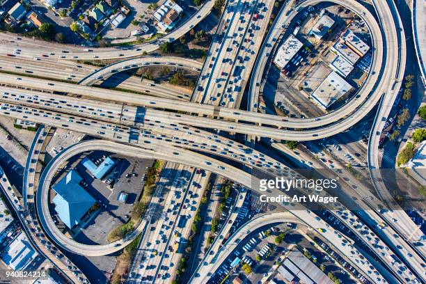 busy los angeles freeway interchange aerial - downtown los angeles aerial stock pictures, royalty-free photos & images