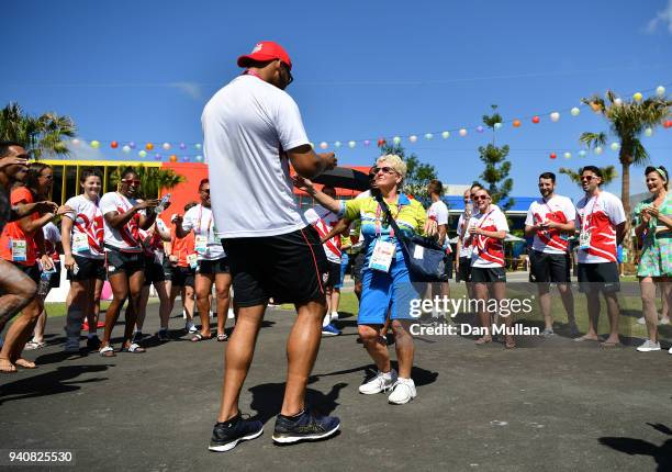 Frazer Clarke of Team England dances with a volunteer during the Team England welcome ceremony at the Athletes Village ahead of the 2018 Commonwealth...