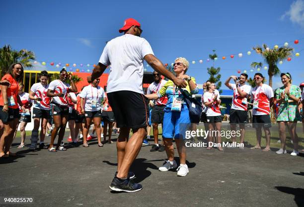 Frazer Clarke of Team England dances with a volunteer during the Team England welcome ceremony at the Athletes Village ahead of the 2018 Commonwealth...