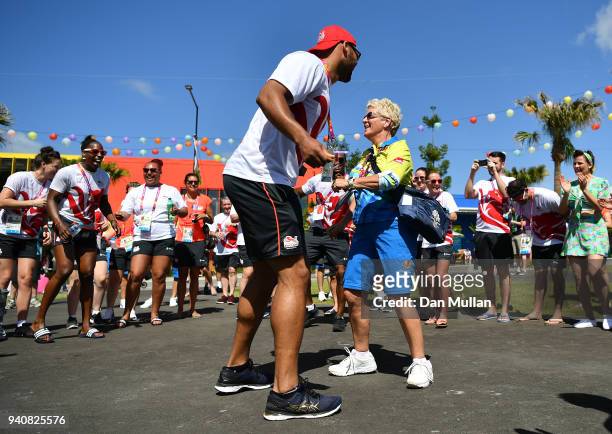 Frazer Clarke of Team England dances with a volunteer during the Team England welcome ceremony at the Athletes Village ahead of the 2018 Commonwealth...