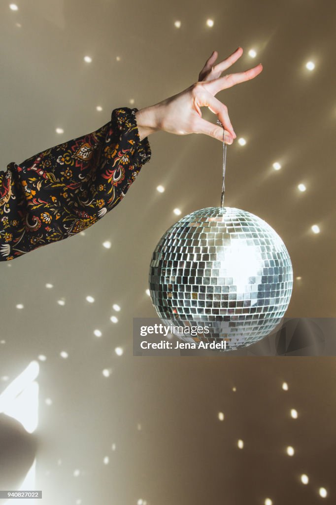 Hand Holding Disco Ball Retro 1970s