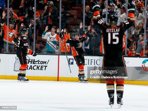 Josh Manson, Ondrej Kase and Ryan Getzlaf of the Anaheim Ducks celebrate Kase's overtime goal as the Ducks defeat the Colorado Avalanche 4-3 in the...