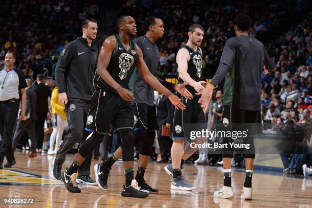 Giannis Antetokounmpo of the Milwaukee Bucks hig fives Khris Middleton of the Milwaukee Bucks and Tyler Zeller of the Milwaukee Bucks during the game...