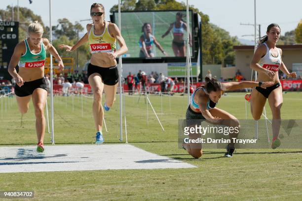 Elizabeth Forsyth tumbles over the line as she wins the Women's Stawell Gift on April 2, 2018 in Stawell, Australia.