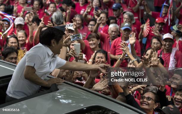 Ferdinand "Bongbong" Marcos Jr, former senator and son of the late dictator Ferdinand Marcos, waves to his supporters after attending the recount of...