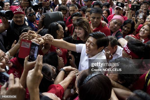 Ferdinand "Bongbong" Marcos Jr, former senator and son of the late dictator Ferdinand Marcos, is surrounded by supporters after attending the recount...