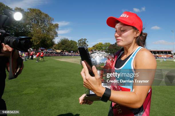 Elizabeth Forsyth takes a phone call straight after winning the Women's Stawell Gift on April 2, 2018 in Stawell, Australia.