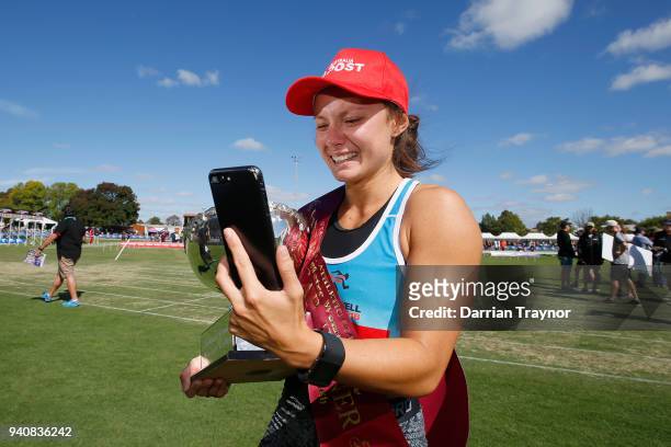 Elizabeth Forsyth takes a phone call straight after winning the Women's Stawell Gift on April 2, 2018 in Stawell, Australia.