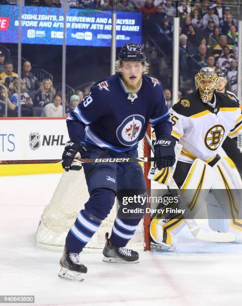 Patrik Laine of the Winnipeg Jets and goaltender Anton Khudobin of the Boston Bruins keep an eye on the play during first period action at the Bell...