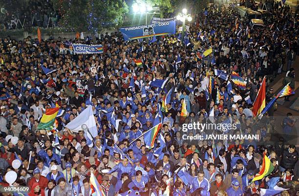Supporters of Bolivian President Evo Morales celebrate his reelection at Murillo square in front of the presidential palace in La Paz on Diciembre 6,...