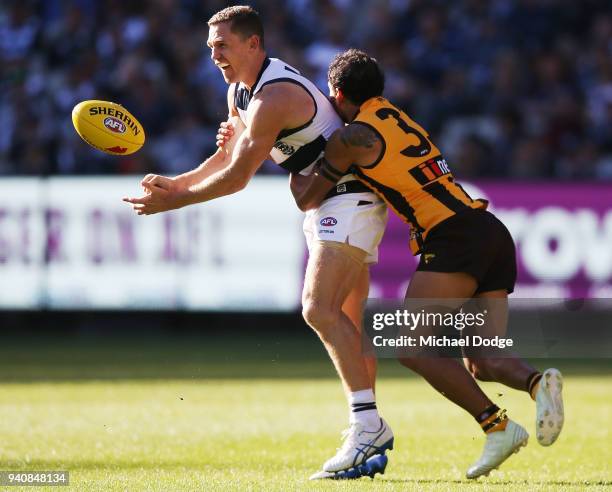 Cyril Rioli of the Hawks tackles Joel Selwood of the Cats during the round two AFL match between the Geelong Cats and the Hawthorn Hawks at Melbourne...