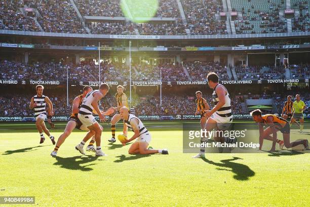 In this seen first time teammates together Joel Selwood of the Cats looks to handball to Gary Ablett as teammate Patrick Dangerfield looks on during...