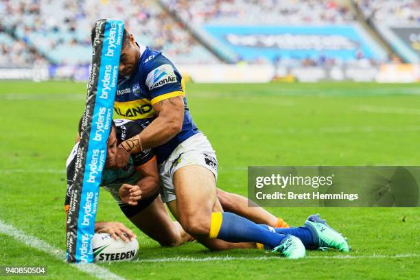 Corey Thompson of the Tigers scores a try during the round four NRL match between the Wests Tigers and the Parramatta Eels at ANZ Stadium on April 2,...