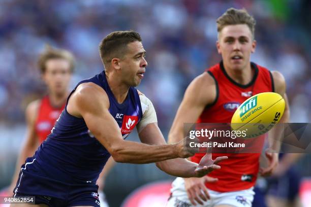 Stephen Hill of the Dockers handballs during the round two AFL match between the Fremantle Dockers and the Essendon Bombers at Optus Stadium on March...