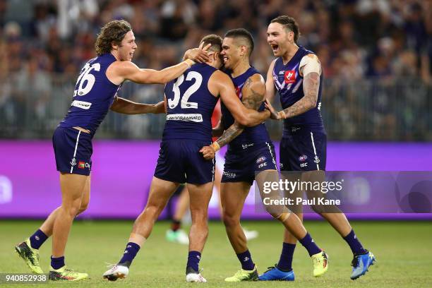 Stephen Hill of the Dockers is congratulated by Ed Langdon, Michael Walters and Nathan Wilson after kicking a goal during the round two AFL match...