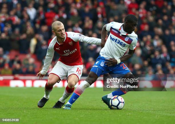 Stoke City's Badou Ndiaye holds of Arsenal's Jack Wilshere during English Premier League match between Arsenal against Stoke City at Emirates...