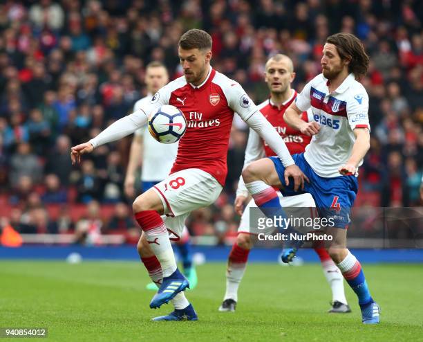 Arsenal's Aaron Ramsey under pressure from Stoke City's Joe Allen during English Premier League match between Arsenal against Stoke City at Emirates...