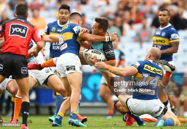 Luke Brooks of the Tigers is tackled during the round four NRL match between the Wests Tigers and the Parramatta Eels at ANZ Stadium on April 2, 2018...