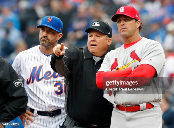 Home plate umpire Fieldin Culbreth goes over the stadium ground rules with Managers Mickey Callaway of the New York Mets and Mike Matheny of the St....