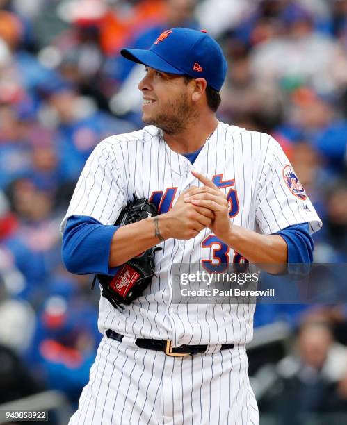 Relief pitcher Anthony Swarzak of the New York Mets looks back as he rubs the baseball during the Mets home opener game of the 2018 MLB baseball...