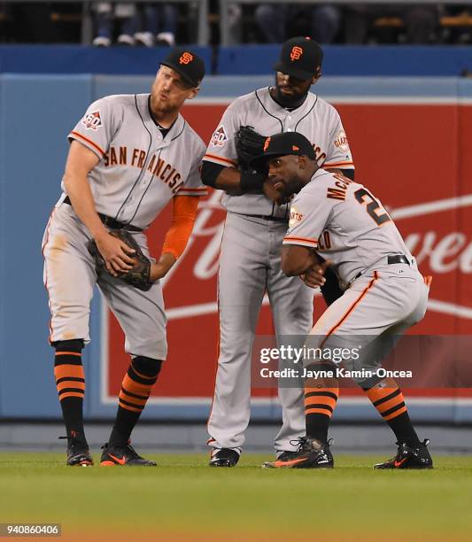 Hunter Pence, Austin Jackson and Andrew McCutchen of the San Francisco Giants celebrate in the outfield after defeating the Los Angeles Dodgers at...