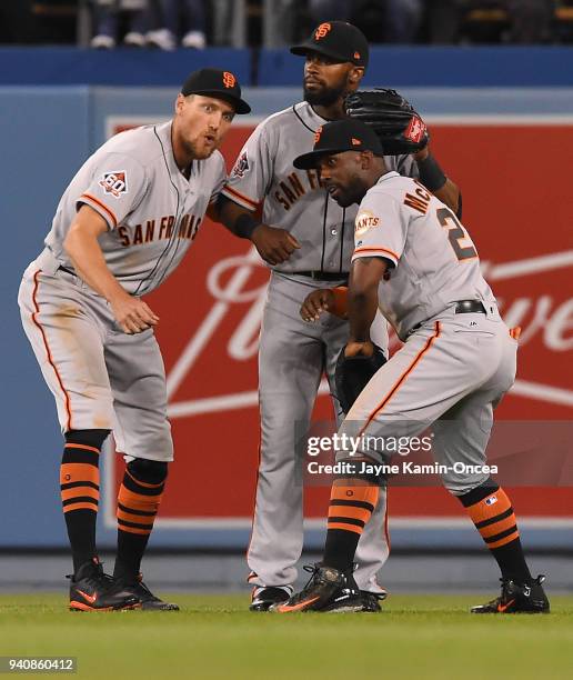 Hunter Pence, Austin Jackson and Andrew McCutchen of the San Francisco Giants celebrate in the outfield after defeating the Los Angeles Dodgers at...